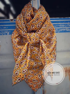 Bright mustard with rust, dark green and white  paisley floral print on a silky charmeuse fabric.